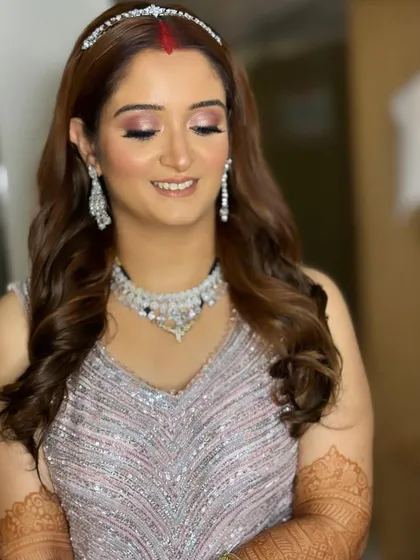 A close-up of the reception makeup. The skin is glowing, and the eyes have a beautiful, soft shimmer.