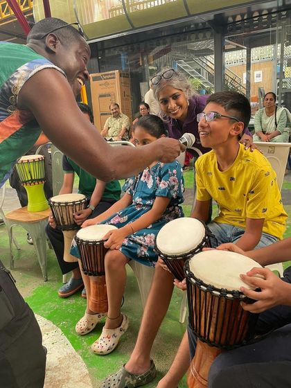 A master drummer from the Guinean ensemble interacts with a young participant during the inclusive drum circle. Each beat resonated with joy and fostered a sense of connection.
