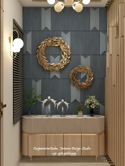 A close-up of the entryway console, featuring a textured wall, gold decorative wreaths, and a sleek wooden cabinet. It's a luxurious and welcoming vignette.