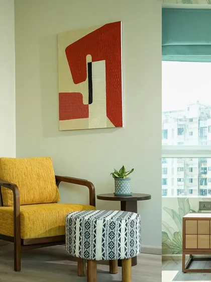 This is a simple, clean composition of a reading nook. My focus here was on the interplay of textures: the woven fabric of the yellow chair, the graphic pattern on the ottoman, and the smooth wood of the side table, all brought together with soft, natural light.
