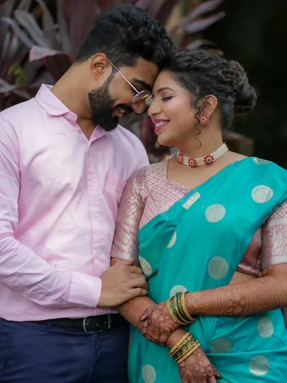 A romantic close-up of the couple, showcasing the bride's beautiful eye makeup and lip color.