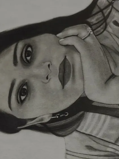 A close-up, angled shot of the finished portrait, highlighting the detailed shading around the eyes and mouth.