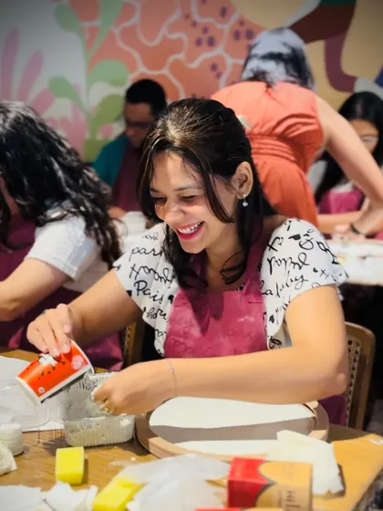 A smile of pure enjoyment. This participant is fully immersed in the creative process of making her 3D moon lamp.