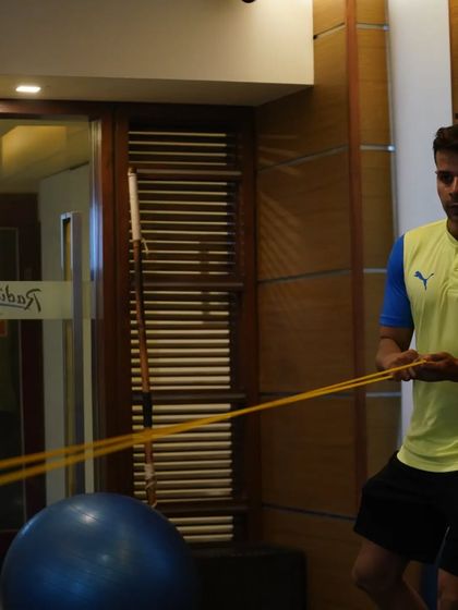 Demonstrating a resistance band exercise. Proper technique is crucial for both effectiveness and safety.
