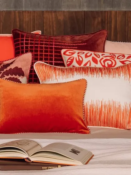 A lavish assortment of our artisanal cushions, each a masterpiece of texture and colour. This collection features vibrant ombre velvets, intricate embroidery, and bold graphic prints, demonstrating how we use these essential accents to layer personality and luxurious comfort into any interior scheme.