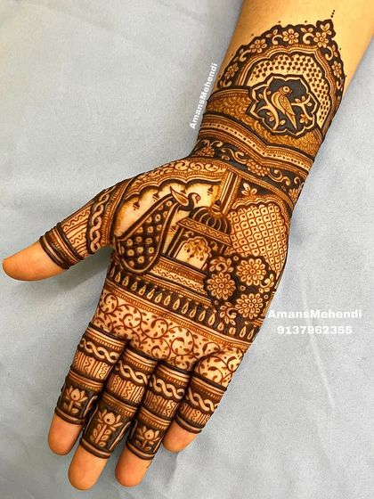 A beautiful and intricate design featuring a bird in a central frame on the palm. The wrist is adorned with a doli (palanquin) motif, symbolizing the bride's journey.