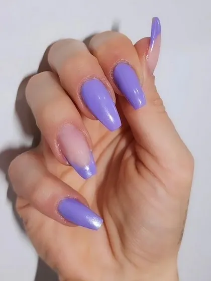 A beautiful solid lavender color on long coffin-shaped nails.