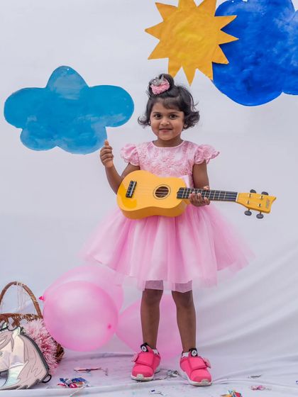 Ready to be the star of the show. This pink party dress, complete with a toy guitar, shows that my designs are made for girls with big personalities and even bigger dreams.