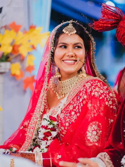 A radiant bride, her joyful smile captured in a candid moment during her wedding ceremony. This portrait highlights her natural beauty and happiness.