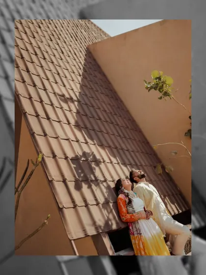 An artistic shot of the couple basking in the sun, with architectural shadows creating a beautiful pattern. We find creative compositions even in traditional settings.