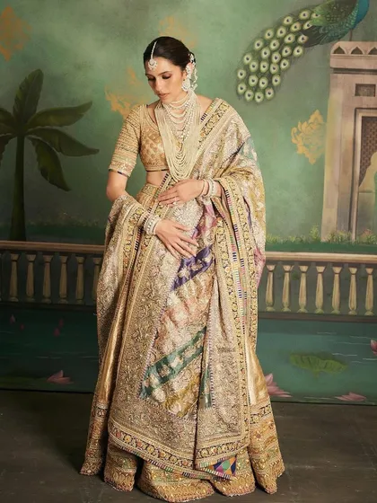 The sheer grandeur of this custom Abu Jani Sandeep Khosla lehenga is breathtaking. The detailed dupatta with animal motifs and the rich gold fabric make it a piece of wearable art.
