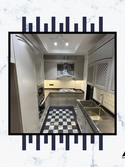 Another view of our popular checkerboard-floored kitchen, showing the ample counter space, deep stainless steel sink, and elegant cabinet hardware.