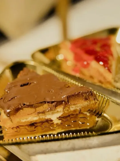 I offer freshly made waffles with a choice of toppings. Here you can see a waffle generously topped with Nutella and another with a sweet strawberry sauce, catering to every sweet tooth.