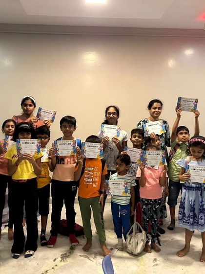 A group of proud campers holding up their certificates after completing the first batch of our summer camp.