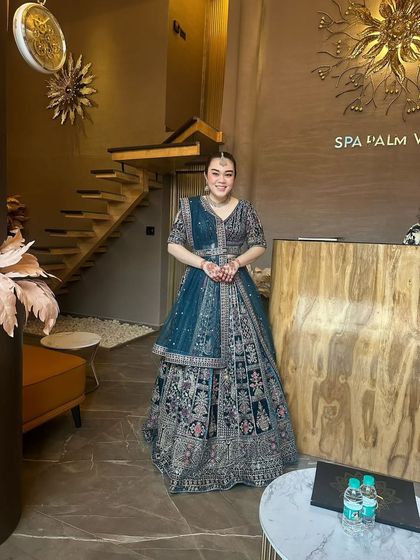 My clients always find the perfect fit. This full-length shot shows the grandeur of the embroidered bridal lehenga, a popular choice for brides.