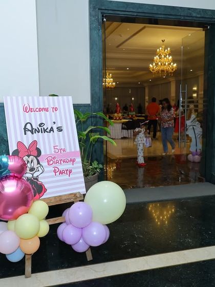 A personalized welcome sign for Anika's 5th birthday party, guiding guests into the Minnie Mouse celebration.
