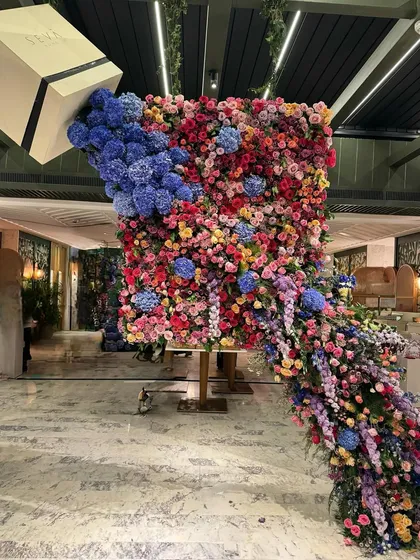 This is what I mean by floral drama. I created this overflowing floral sculpture for a product launch, designing it to feel like a continuous, abundant cascade of color and life. It's a perfect example of how I use flowers to create a bold, unforgettable statement.