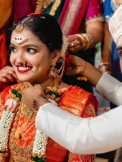 A beautiful moment where the groom helps the bride with her jewelry during the ceremony. We capture these small acts of love and care.