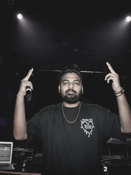 Facing the camera with both hands up. I'm here to lead the party and make sure everyone is having the best time.