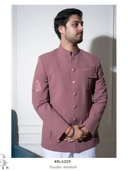 A diptych showing both a side profile and a close-up of the sleeve embroidery on our pink Prince Coat. This highlights the jacket's sharp tailoring and the delicate, tonal floral artwork.