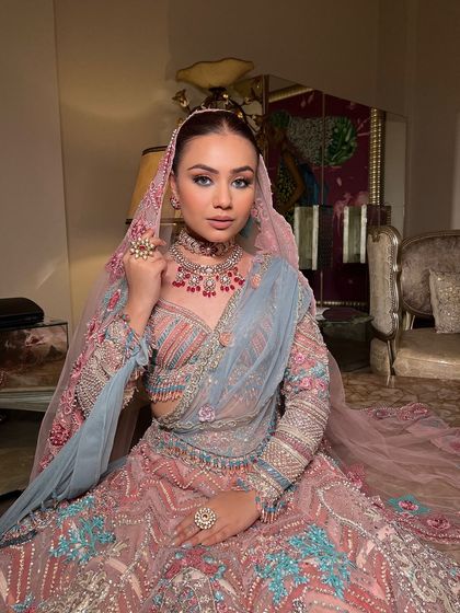 The bride looking like royalty in her stunning outfit and elegant updo.