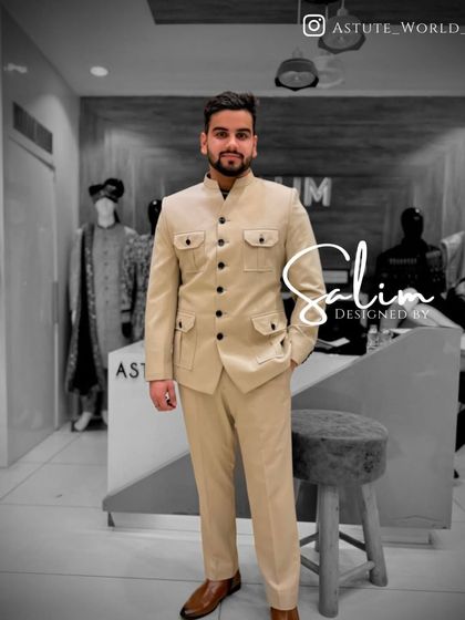 A client wearing a beige Jodhpuri-style suit with four front pockets. This safari-inspired design is a stylish and versatile option for various occasions.