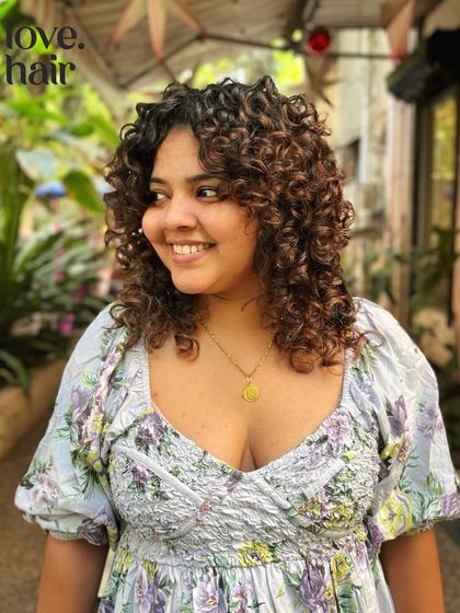 Another look at this gorgeous curly bob, showing how the layers frame the face and create a beautiful silhouette from every angle.