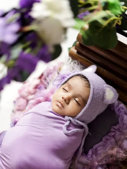 An overhead shot showing the baby nestled in a basket of flowers. This angle highlights how small and precious they are, creating a beautiful keepsake.