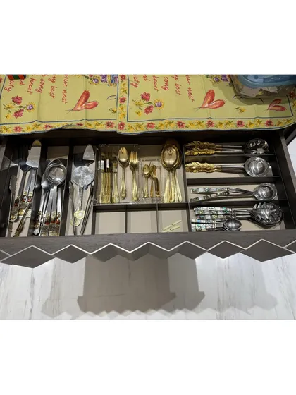 A drawer for special occasion cutlery, with a beautiful runner laid on top for protection. We believe in making every part of your kitchen functional and beautiful.