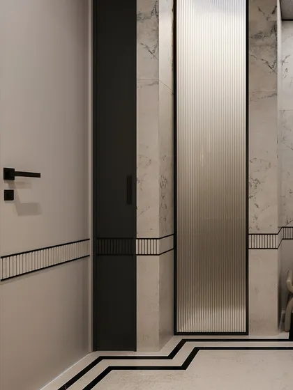 A detail of the bathroom's material palette, showing the fluted glass panel, marble walls, and the geometric black inlay on the floor.