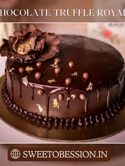 An elegant Chocolate Truffle Royale cake with a glossy glaze, gold leaf, and a handcrafted chocolate flower.