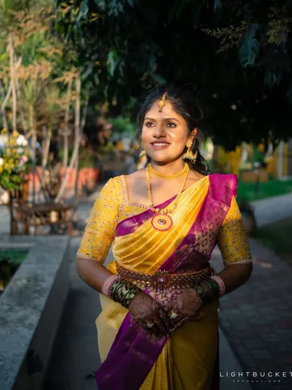 A beautiful yellow and purple Kanchivaram saree paired with a fully embroidered yellow blouse. The color combination is traditional yet vibrant.
