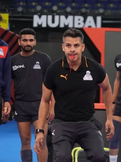 Leading the team through a warm-up on the mat. My focus is on getting them physically and mentally ready to compete.