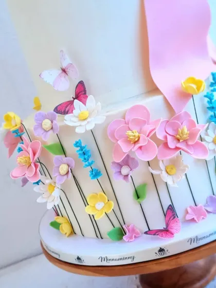 A detailed close-up of the handcrafted sugar flowers and butterflies. I love adding these small touches that make the cake feel alive.