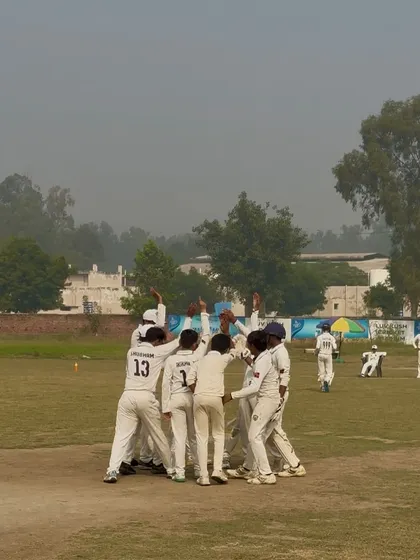 The team celebrates a run-out. Every player is involved.