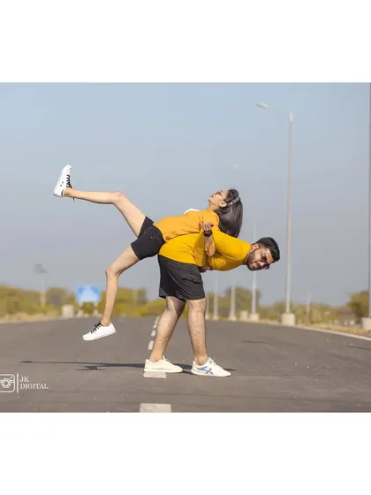 A playful and acrobatic pose that shows the couple's fun-loving spirit. I always encourage couples to be themselves and have fun during the shoot.