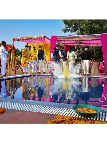 The big splash. Capturing the exact moment the groom is thrown into the pool makes for an unforgettable, action-packed memory.