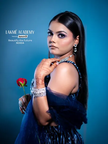 A modern and chic party look. The simple red rose adds a pop of color to the monochromatic blue outfit, while the makeup remains glamorous and sophisticated.