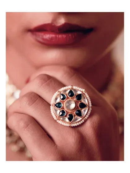 A statement without saying a word. This oversized cocktail ring, featuring gold, pearl, and green stones, is striking and just right for evening celebrations.