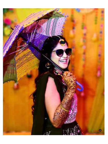 A fun and stylish shot from a Mehndi ceremony. We love capturing the playful side of wedding traditions, showing the bride's personality with creative props and candid expressions.