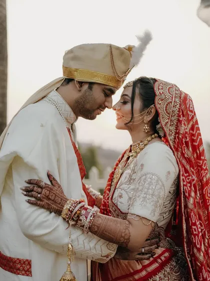 A classic, romantic portrait of the bride and groom. Their foreheads touching, eyes closed, they are lost in their own world on their wedding day.