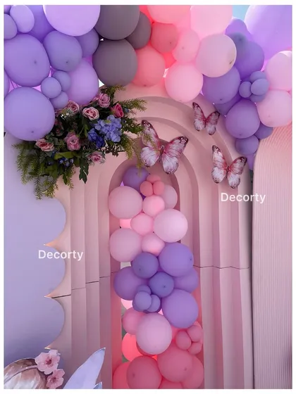 A detailed shot of the balloon arch with butterfly accents, creating a magical entryway.