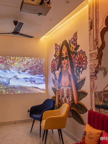 This family lounge doubles as a home theater. A projector is installed on the ceiling, turning the main wall into a large screen for an immersive movie-watching experience.