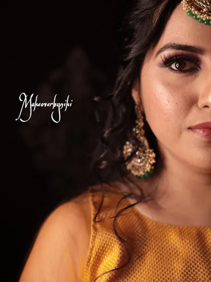 An artistic half-face portrait showing the detail of the eye makeup for Chinmayi's mehendi ceremony.