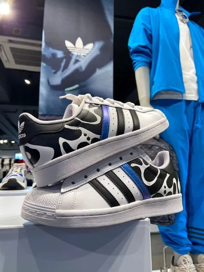 These Adidas Superstars feature a custom cow-print pattern with a pop of metallic blue. Just one of the many unique designs from the live event.
