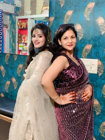 A fun back-to-back pose with a happy client. Her makeup is perfect for a sangeet or reception event.