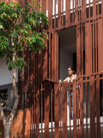 The operable sections of the facade screen at the 'Ittige' residence. This feature allows residents to modulate the amount of light, air, and connection to the outside, making the building adaptable to different times of day and weather.