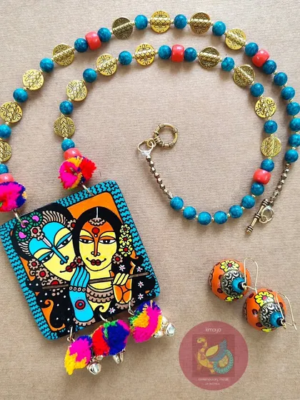 The complete Radha Krishna hand-painted jewellery set, laid out to display the harmony between the necklace and the matching wooden jhumka earrings.