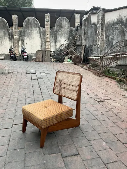 The 'Kangaroo' chair from another angle, highlighting the craftsmanship of the wooden frame.