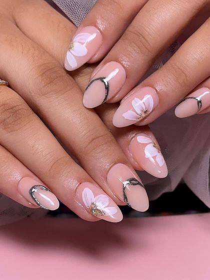 A delicate and dreamy set with hand-painted white flowers on a sheer pink base, accented with abstract silver chrome details.